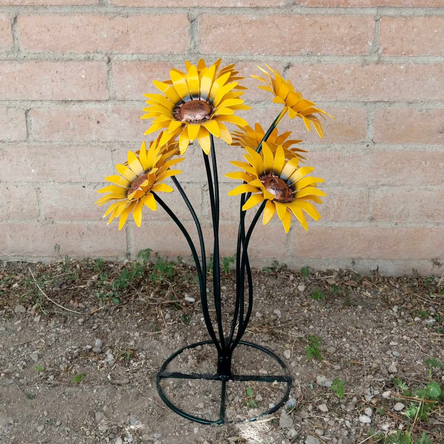 A metal sunflower bouquet with bright yellow petals and copper centers on black-green stems.