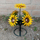 A metal sunflower bouquet with bright yellow petals and copper centers on black-green stems.