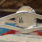 Close-up of the artisan's stamped signature.