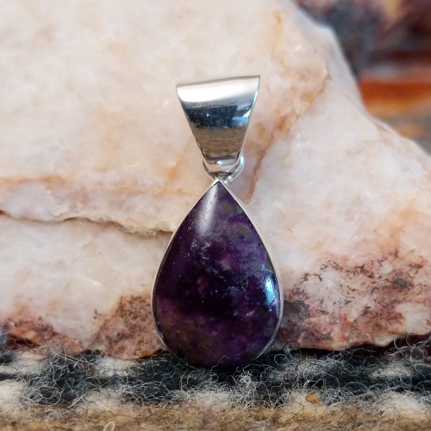 Sugilite set within a teardrop shaped sterling silver bezel.