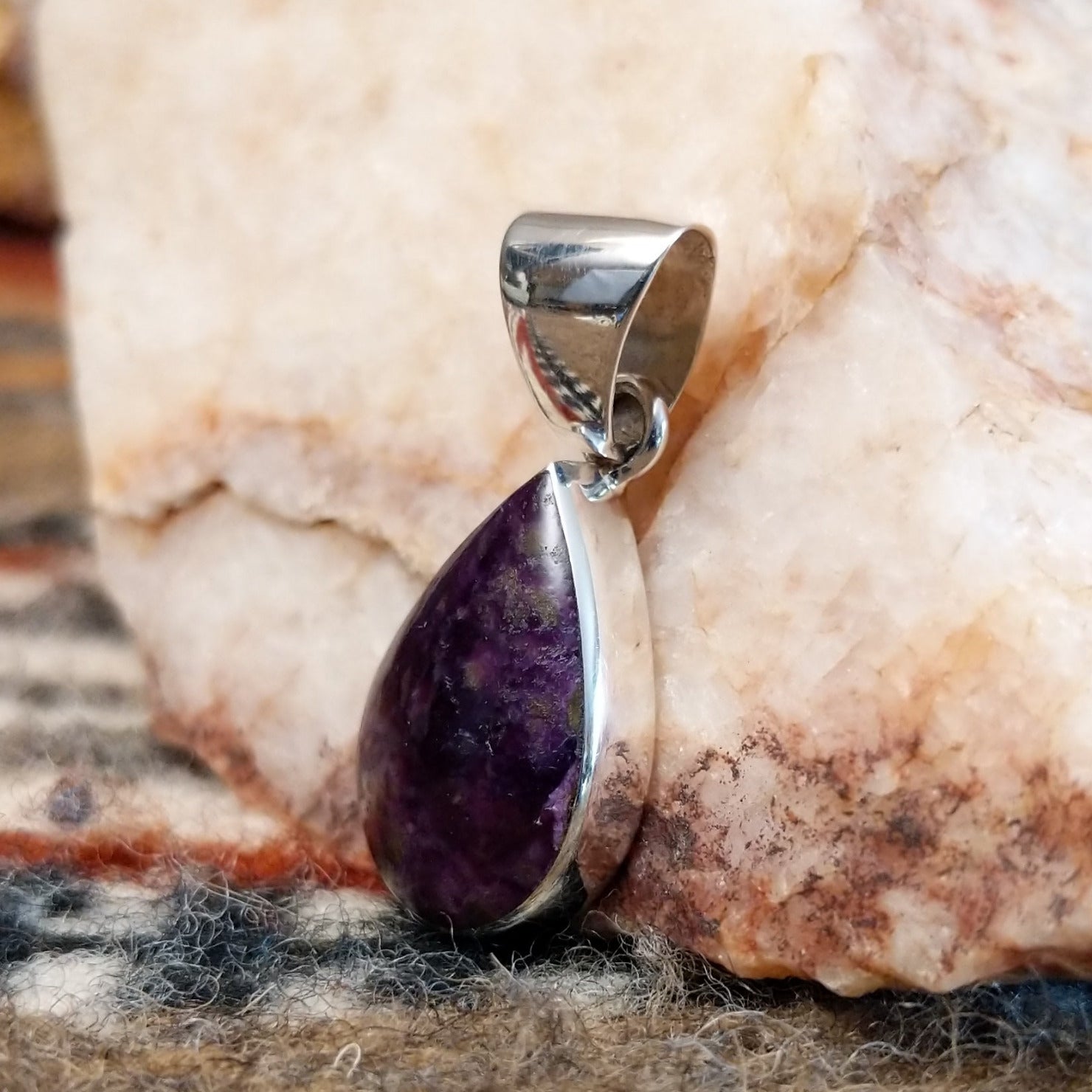 Sugilite set within a teardrop shaped sterling silver bezel.