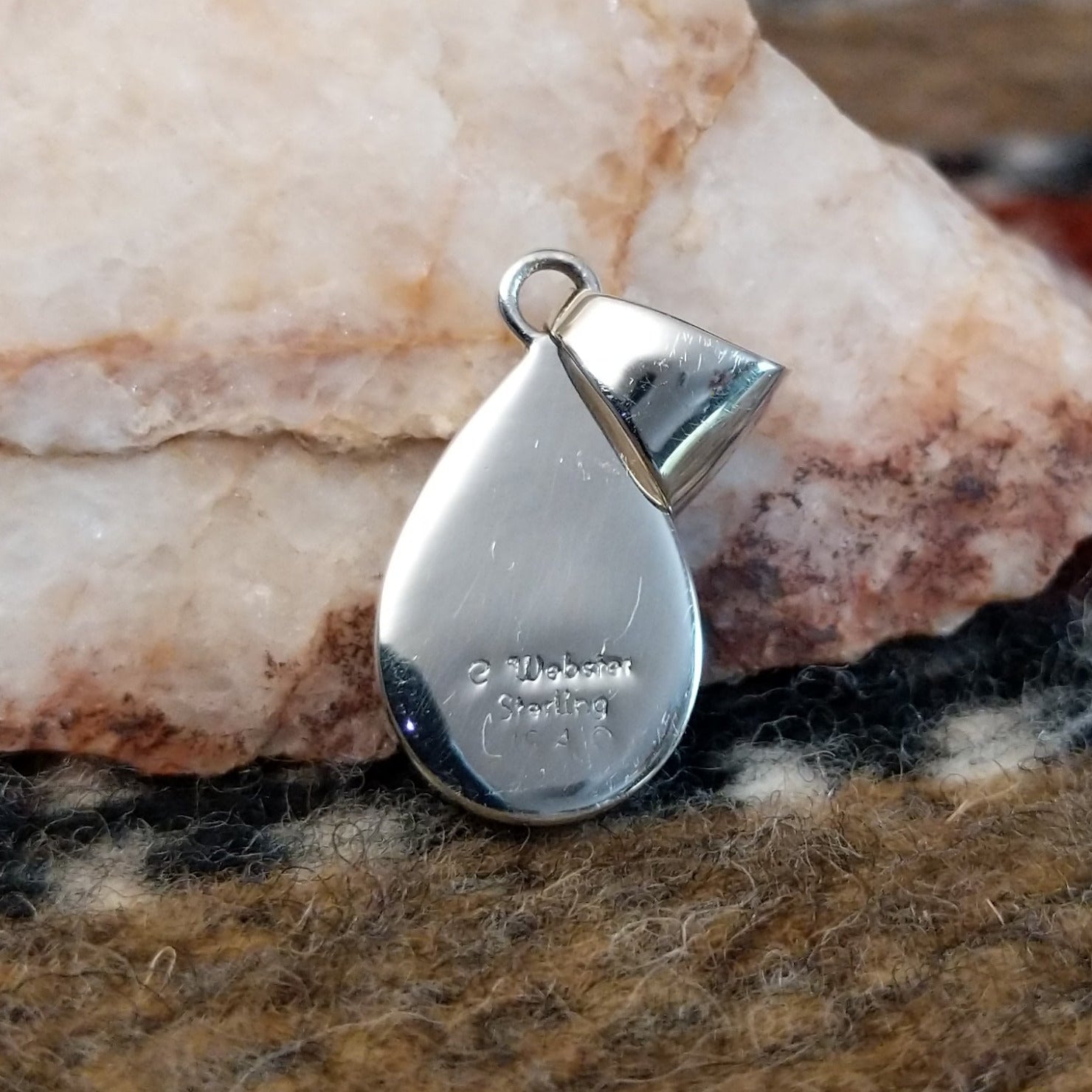 The back features the artisan's stamped signature.