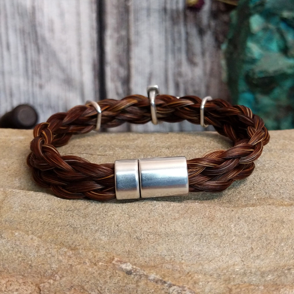 Magnetic clasp on the back of the bracelet.