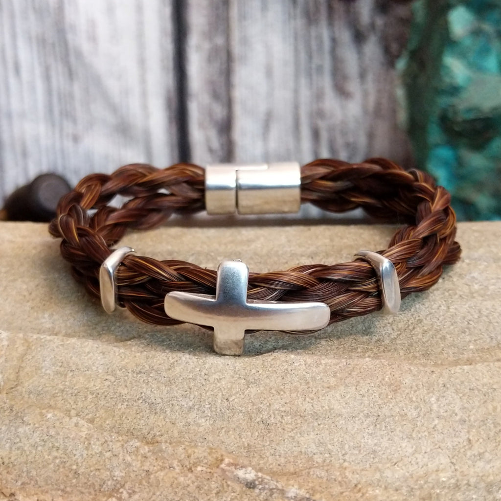 Braided brown horsehair bracelet with metal cross accent.
