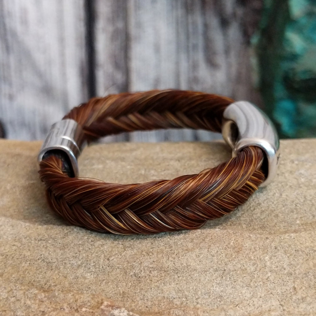 A braided brown horsehair bracelet with barbed wire detailing.