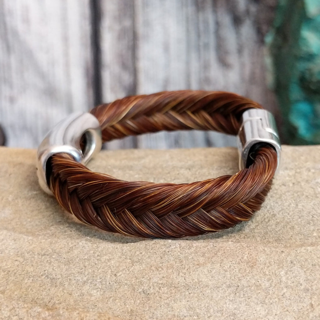 A braided brown horsehair bracelet with barbed wire detailing.