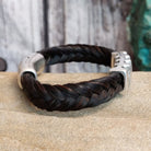 Braided dark brown horsehair bracelet with a metal grille accent and a magnetic clasp.