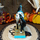 Resin gray appaloosa pony painted with turquoise Native American motifs along the body.