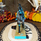 Resin gray appaloosa pony painted with turquoise Native American motifs along the body.