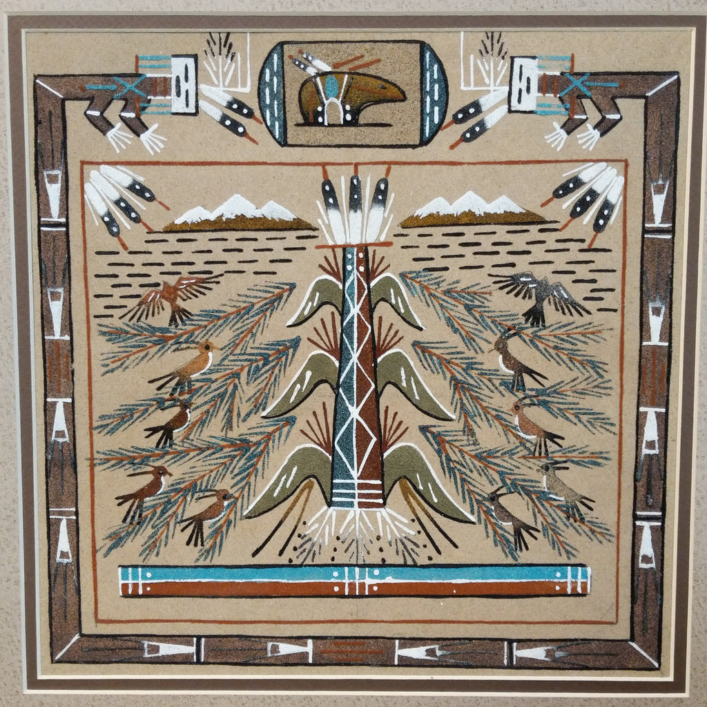 A close-up of the tree of life and detailed sand painting.