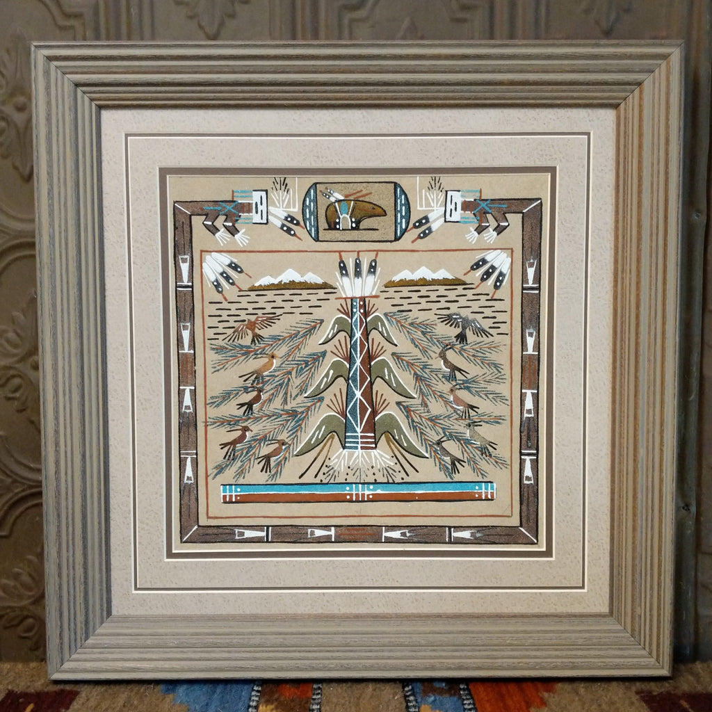 Sand used to depict the tree of life and is set within a wooden frame.