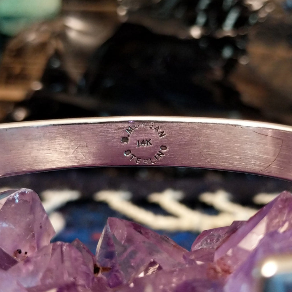 The artist's signature and gold authentication is found inside of the band.