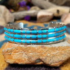 Handcrafted sterling silver three-row cuff by Sheldon Lalio featuring sleek channel inlay detailing across three parallel bands of turquoise with polished sterling silver craftsmanship.