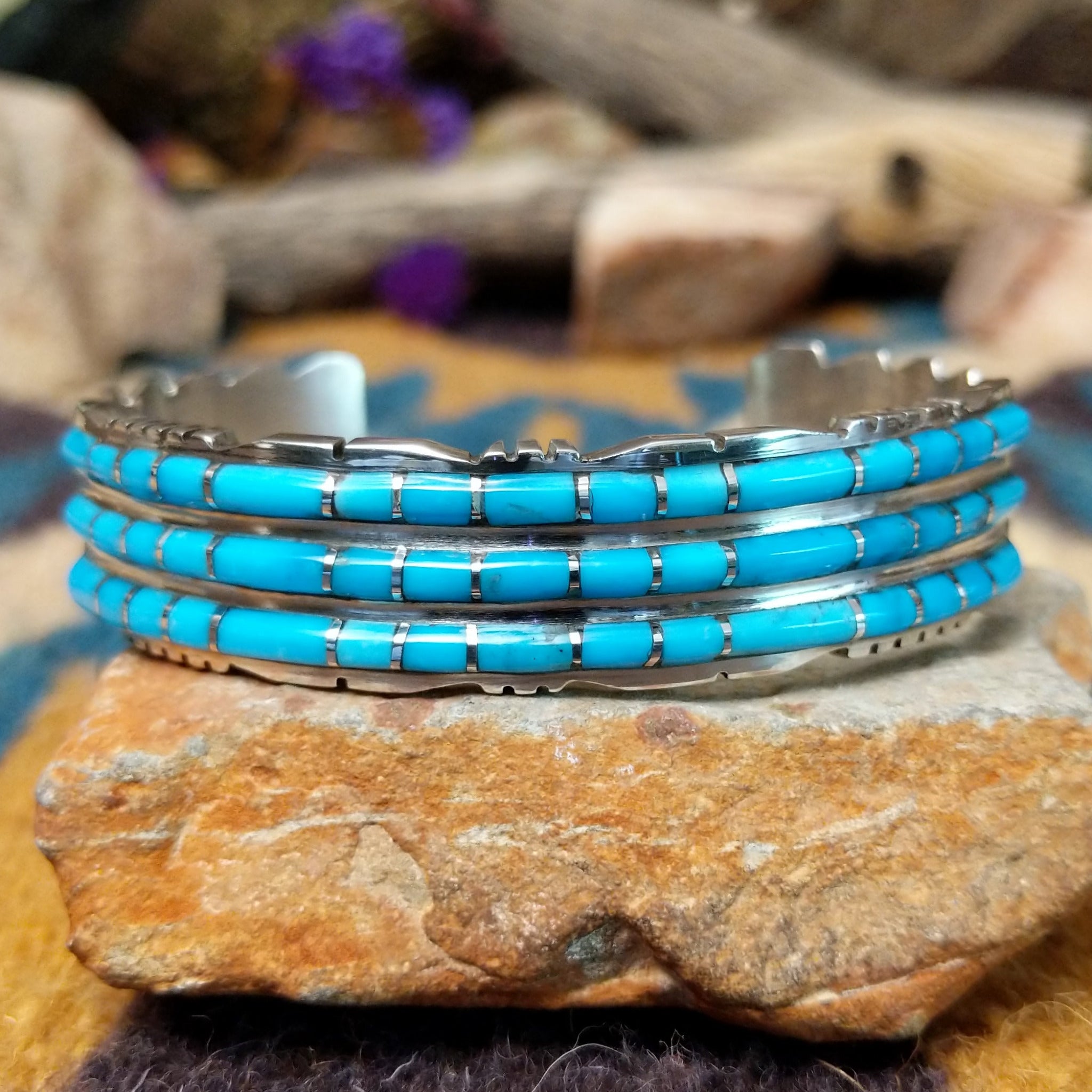 Handcrafted sterling silver three-row cuff by Sheldon Lalio featuring sleek channel inlay detailing across three parallel bands of turquoise with polished sterling silver craftsmanship.