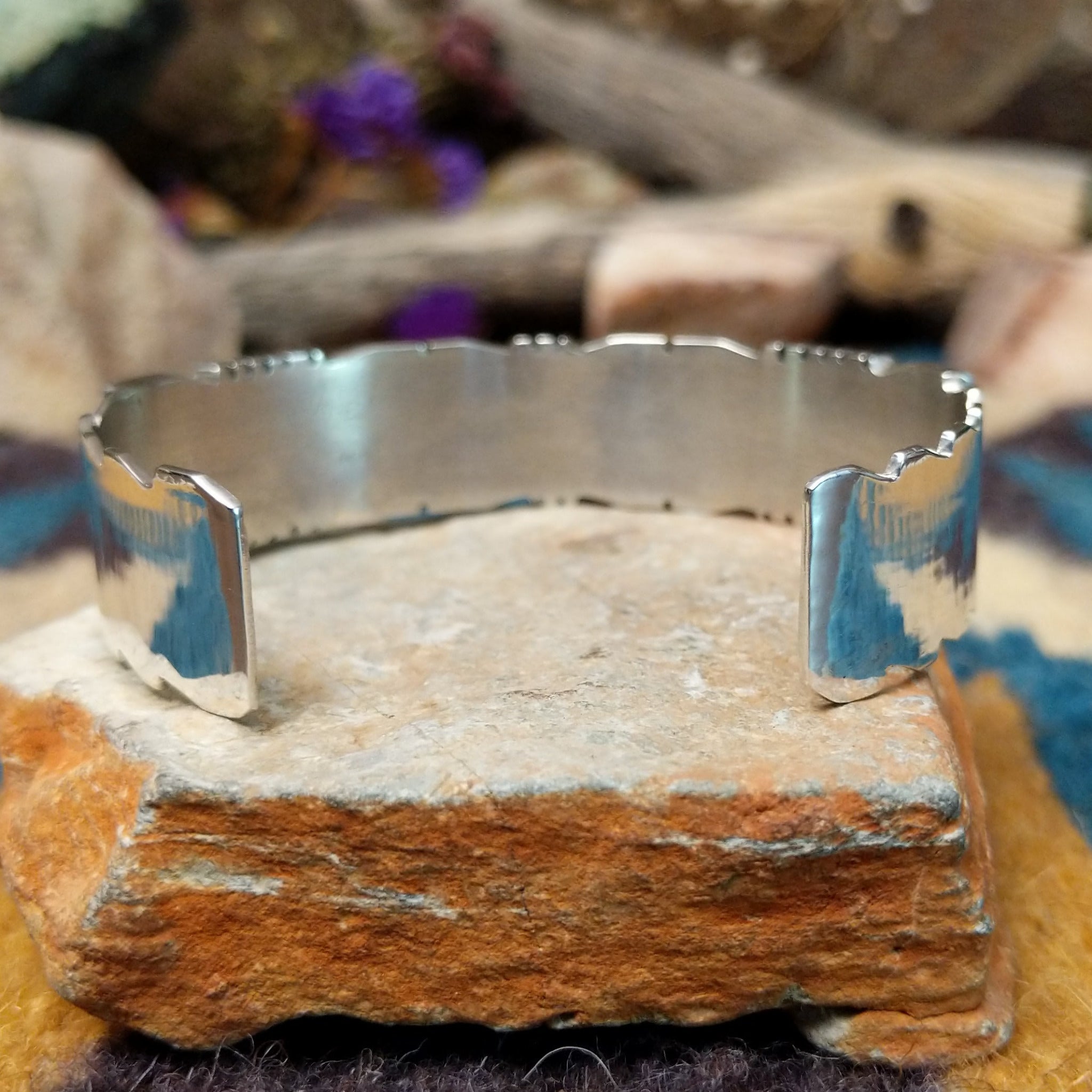 Handcrafted sterling silver three-row cuff by Sheldon Lalio featuring sleek channel inlay detailing across three parallel bands of turquoise with polished sterling silver craftsmanship; underside view.