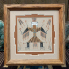 Framed Navajo sand painting of Thunder People with lightning-like details and wing-shaped elements.