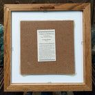 Backside of the Thunder People sand painting, showing the Certificate of Authenticity and Artist information. 
