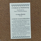 Close up of the Certificate of Authenticity and Artist information. 