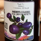 Bottle of huckleberry jam with a label showing ingredients.