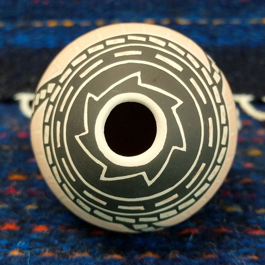 The top of the seed pot reveals the small opening and various designs.