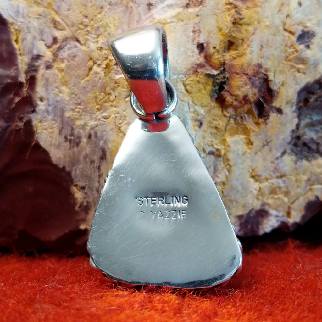 The back features the artisan's stamped signature.