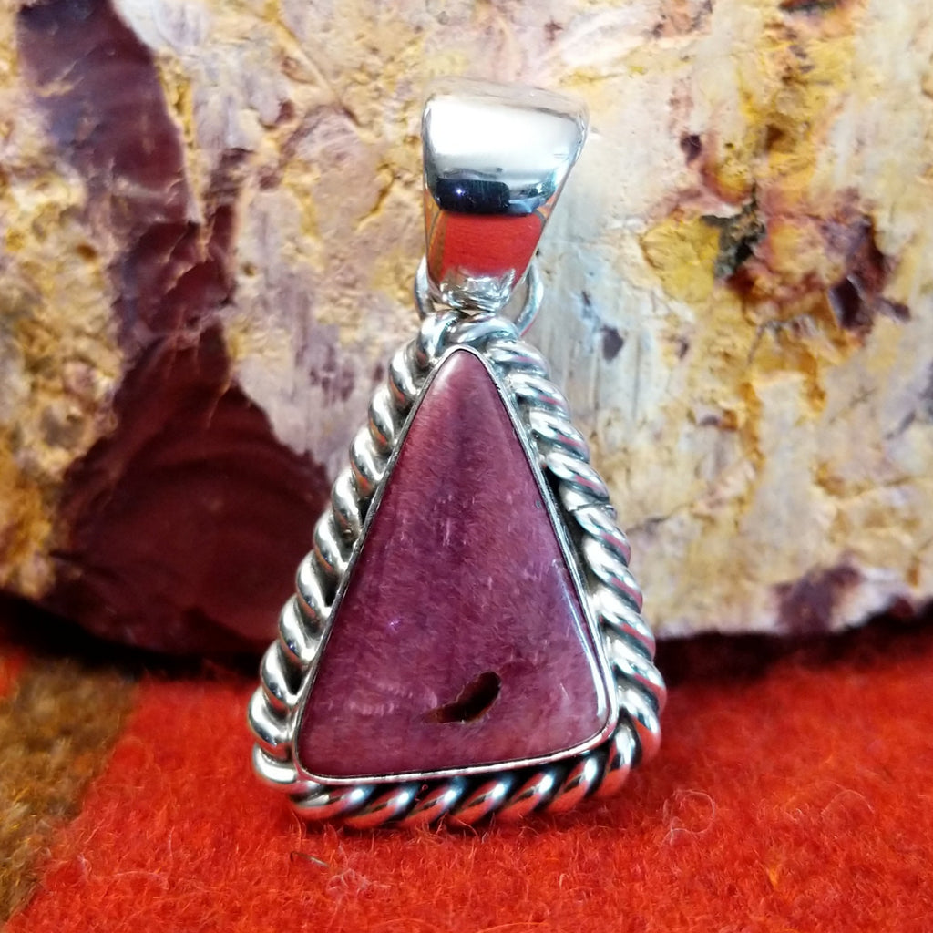 Triangular purple spiny oyster shell set in sterling silver with twisted rope frame.