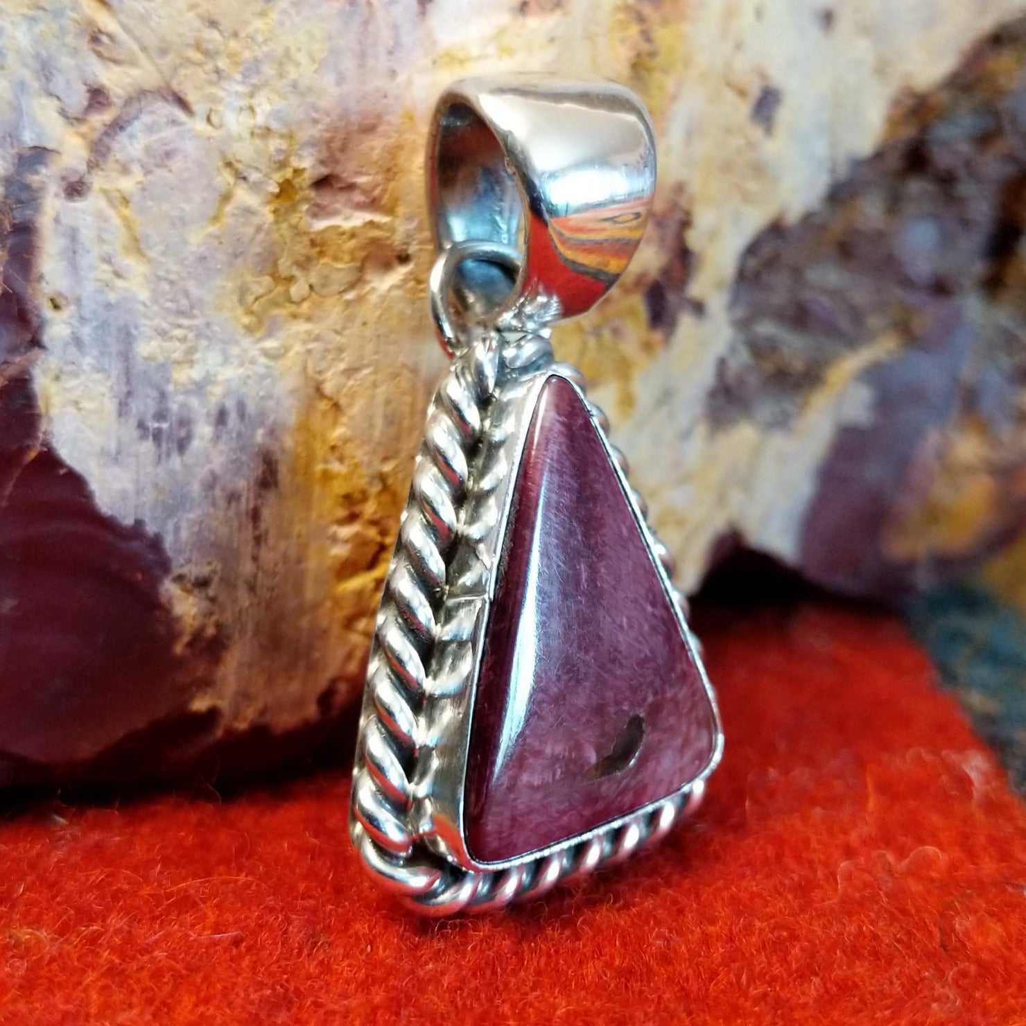 Triangular purple spiny oyster shell set in sterling silver with twisted rope frame.