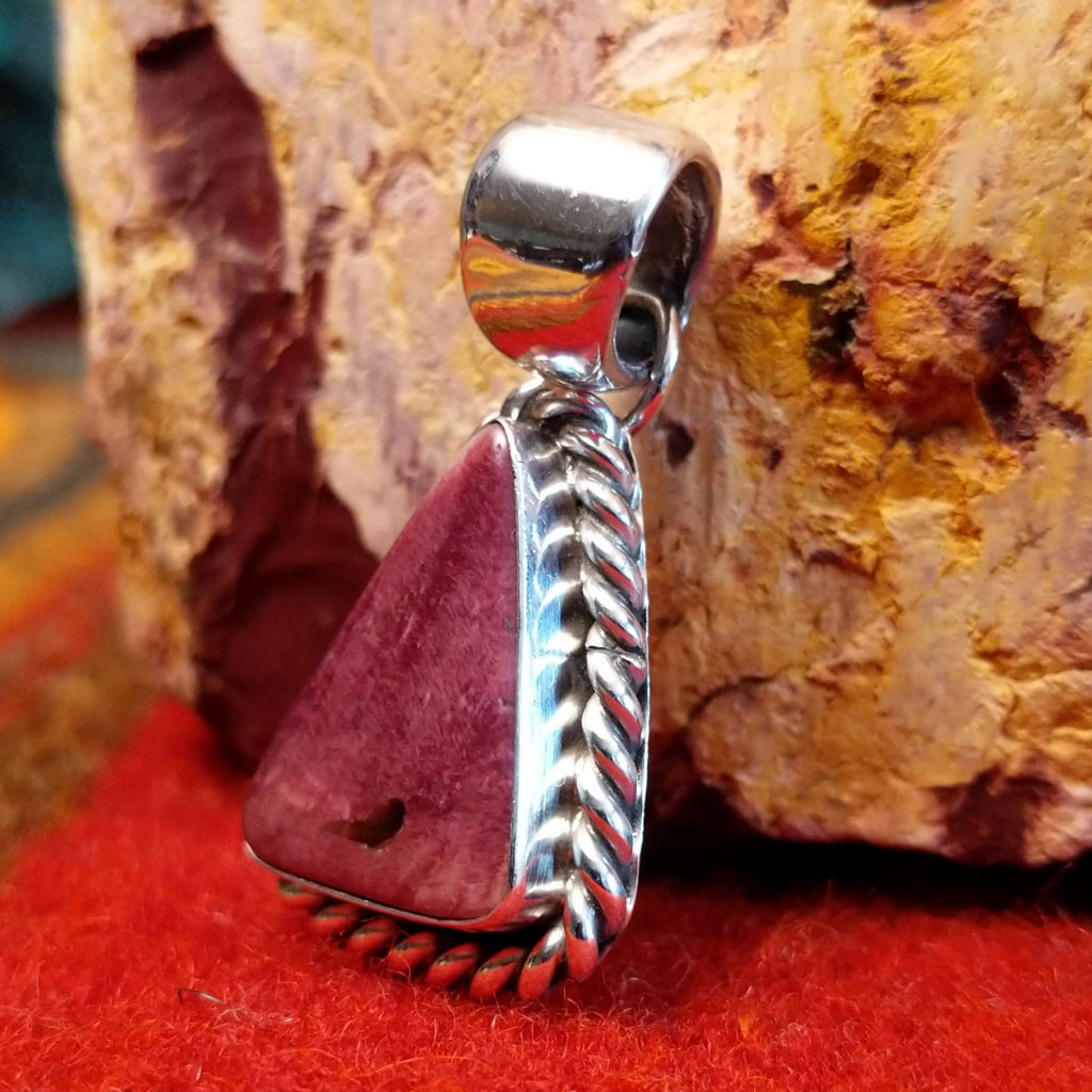 Triangular purple spiny oyster shell set in sterling silver with twisted rope frame.