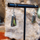 Blackjack turquoise set within the triangular bezels of the earrings.