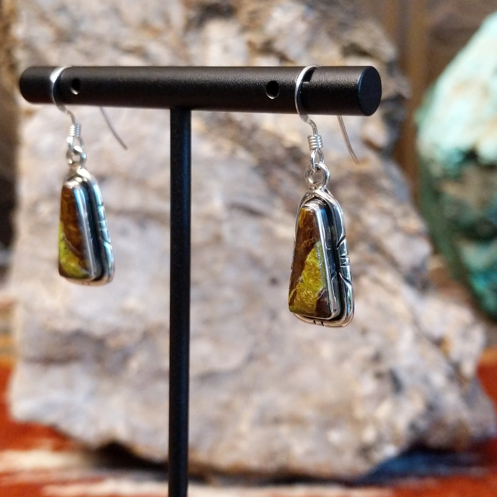 Blackjack turquoise set within the triangular bezels of the earrings.