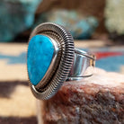 Sterling silver ring with triangular turquoise and twisted rope bezel.
