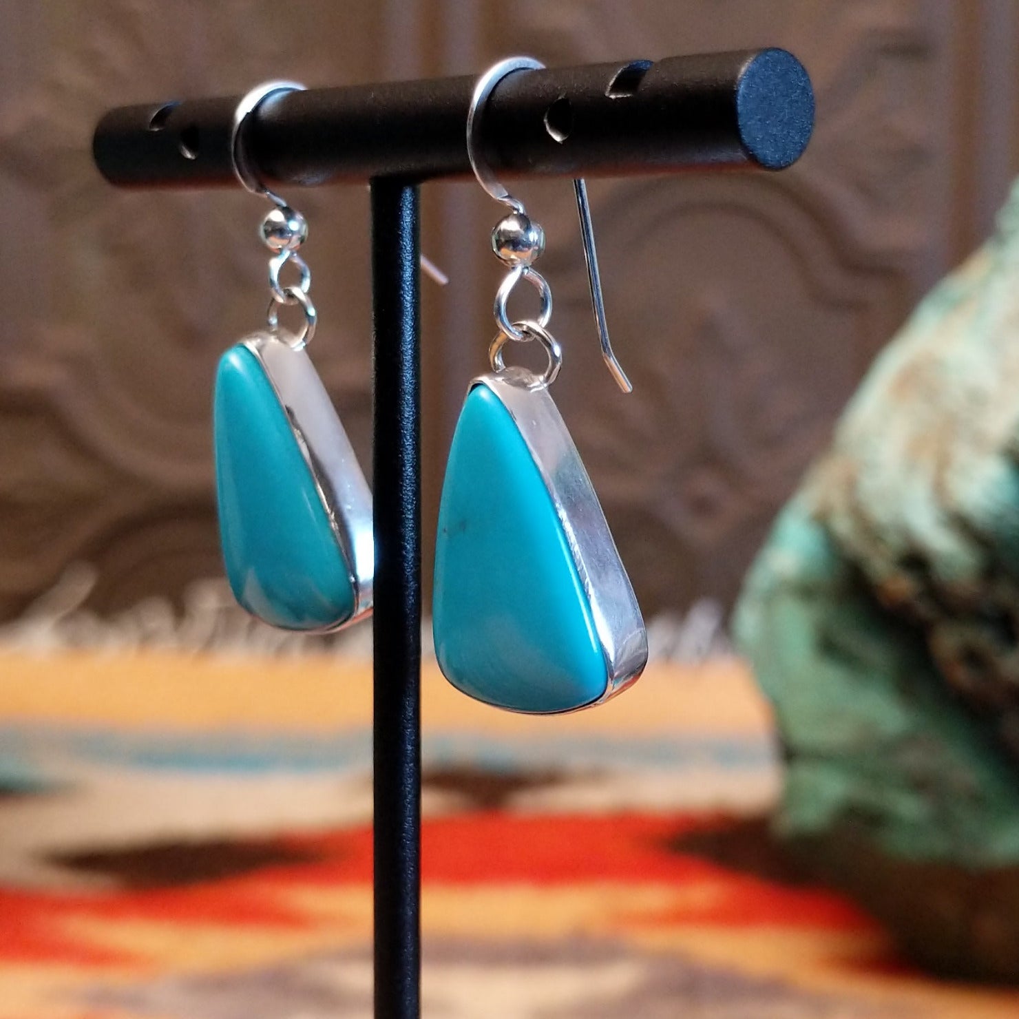 Triangular sterling silver dangle earrings with Kingman turquoise set in the bezels.