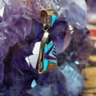 14kt gold Donald Douglas triangular pendant with geometric multistone inlay.