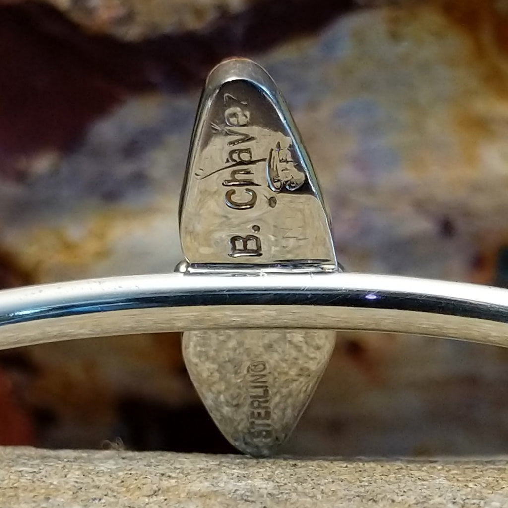 The underside of the bezel is stamped with the artist's signature.