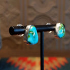 Sterling silver triangular post earrings with sonoran gold turquoise set in the bezels.