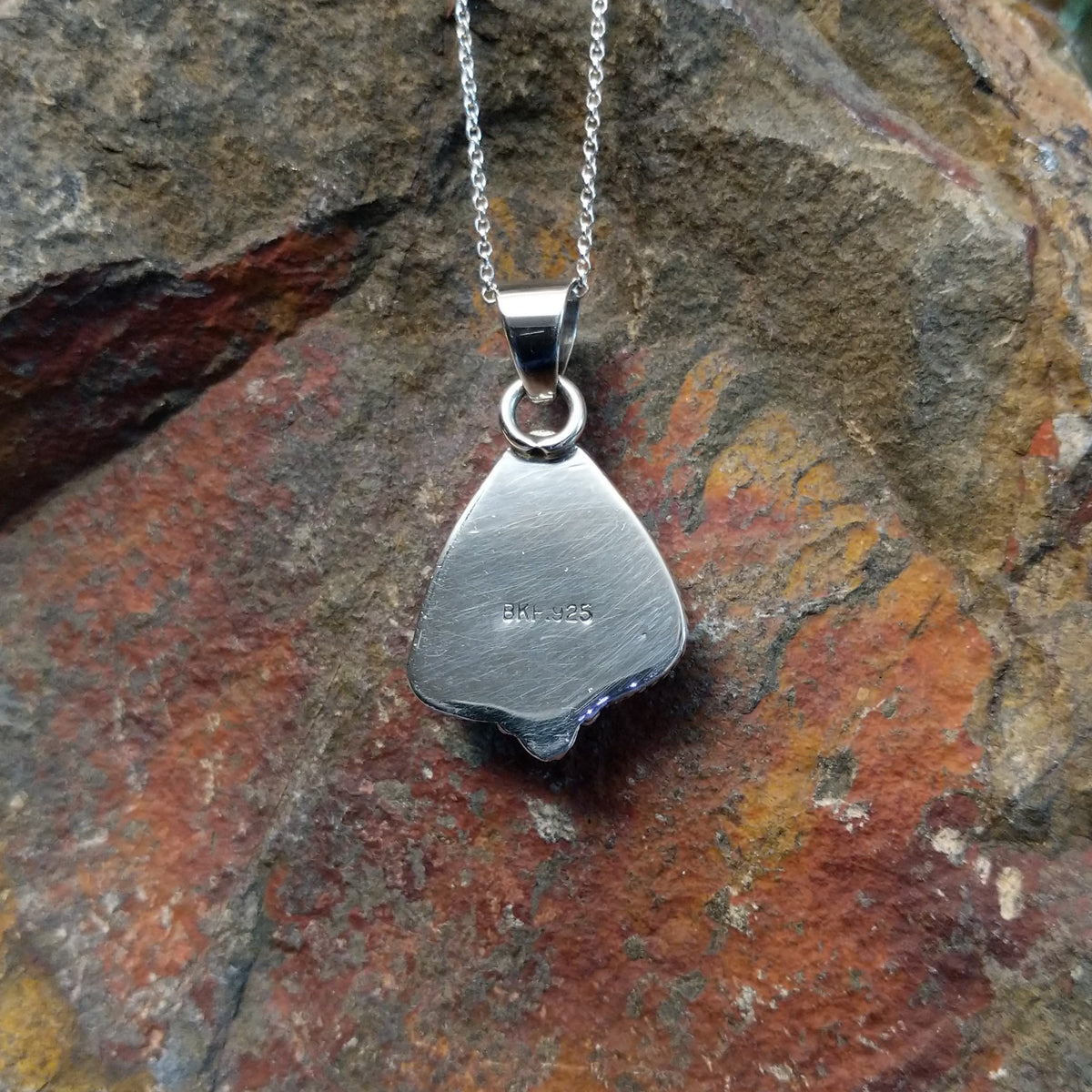 Triangular turquoise pendant by Burt Francisco featuring a bright blue turquoise stone framed with twisted sterling silver rope and decorative silver drops; artisan and .925 (Sterling Silver) stamp.