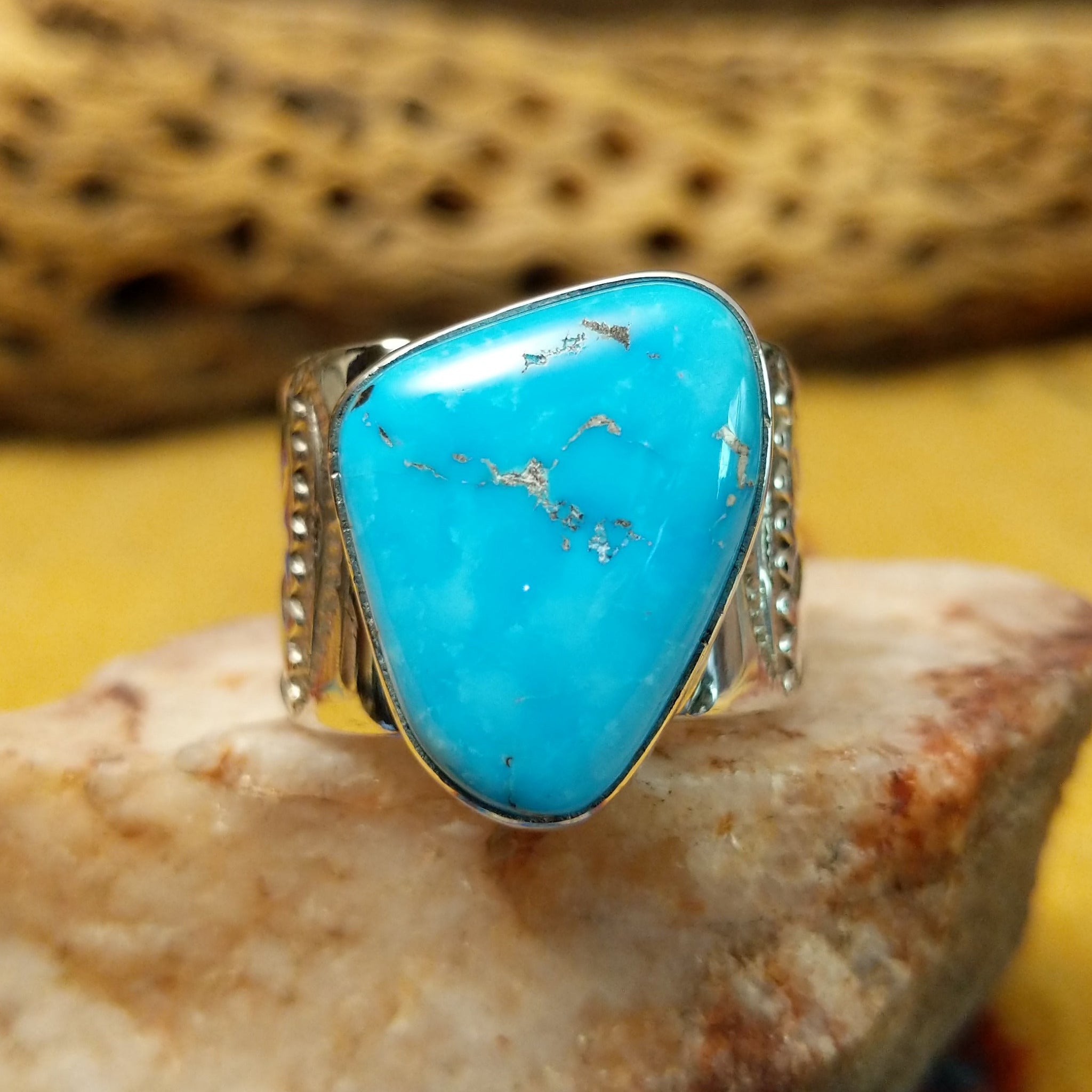 Triangular turquoise ring by E. Piaso, featuring a vibrant blue turquoise stone with natural matrix set in a handcrafted sterling silver band.