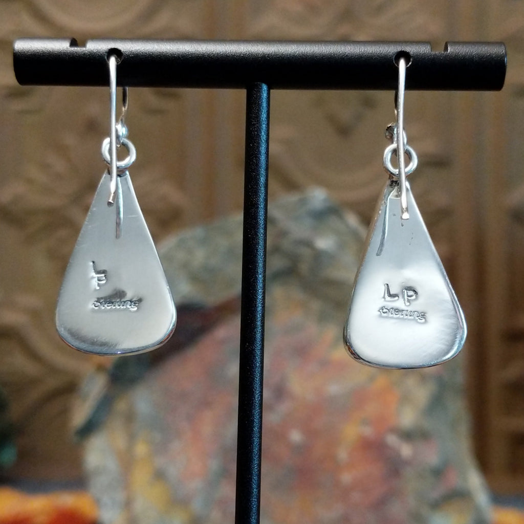 The back of the earrings showcase the tangle hooks and artist's stamp.