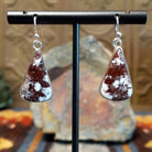 Triangular wild horse stone set in a smooth silver bezel.
