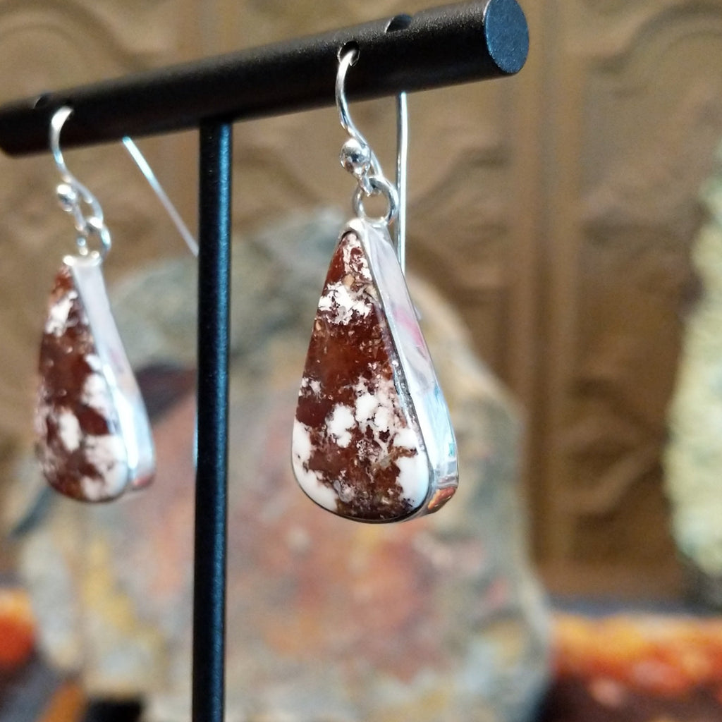 Triangular wild horse stone set in a smooth silver bezel.