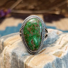 Sterling silver ring with Sonoran gold turquoise set in the bezel, framed by coiled accents.