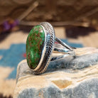 Sterling silver ring with Sonoran gold turquoise set in the bezel, framed by coiled accents.