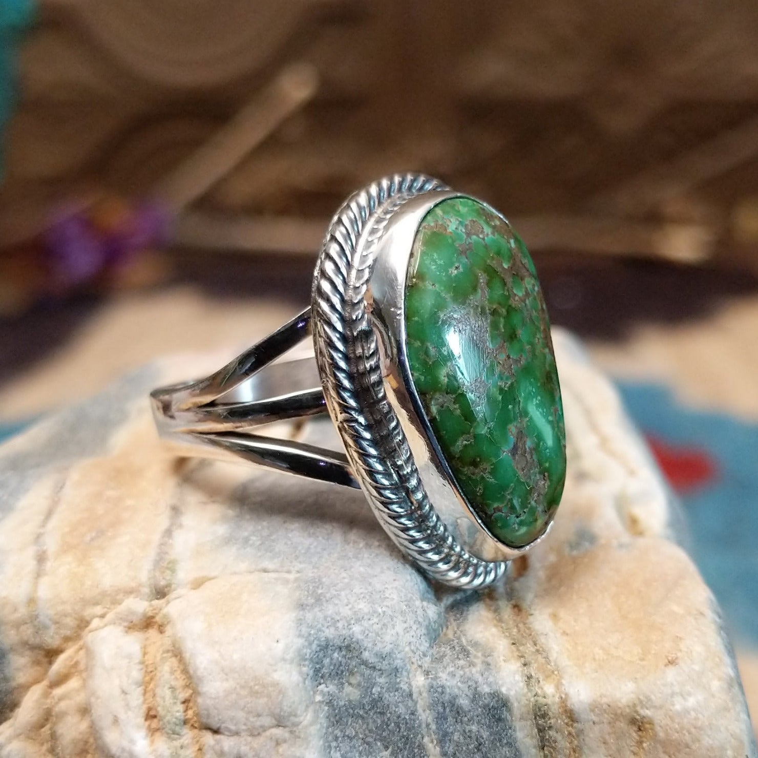 Sterling silver ring with Sonoran gold turquoise set in the bezel, framed by coiled accents.