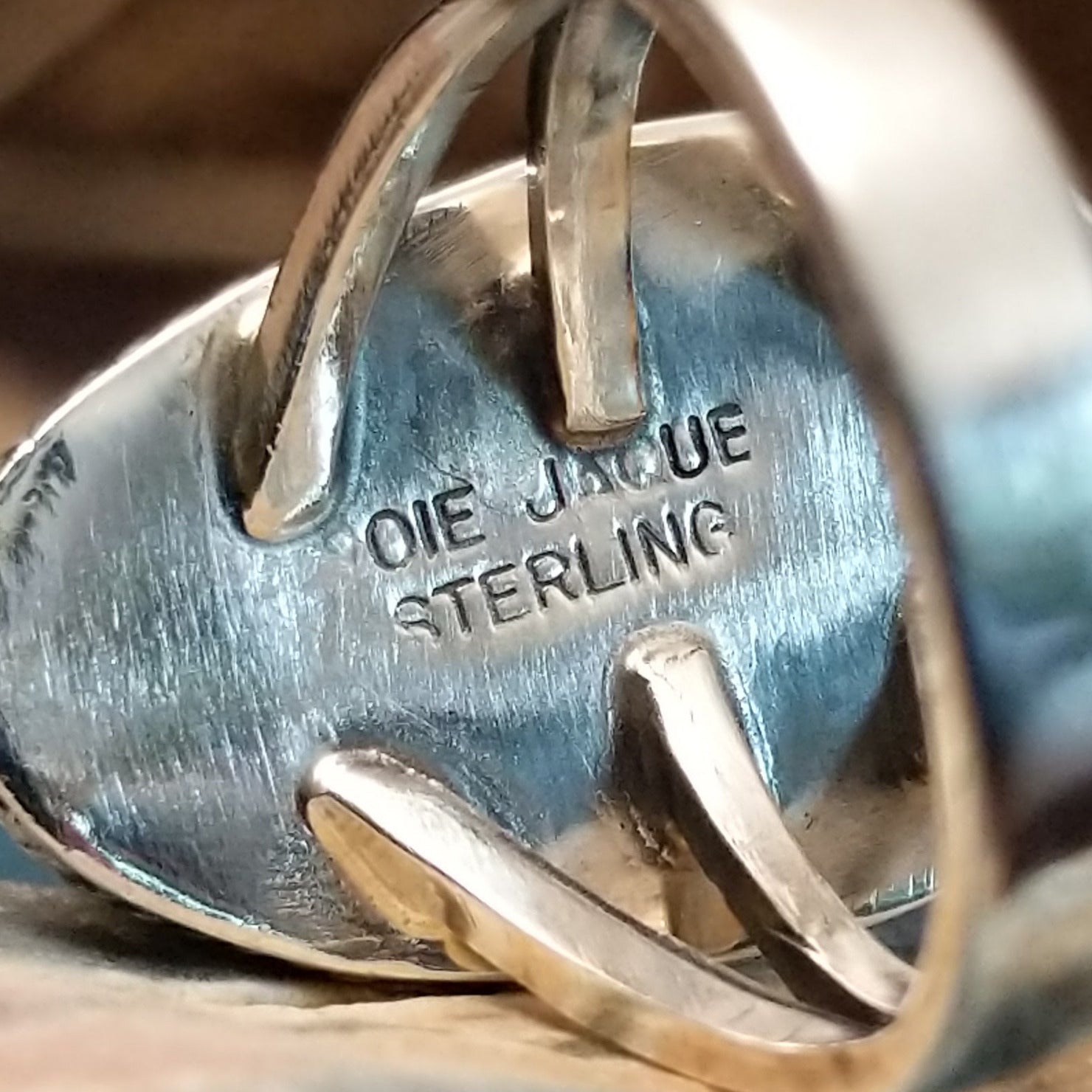 Close-up of the artisan's stamped signature.