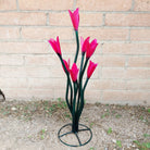 A medium metal tulip sculpture, with painted vivid pink petals.