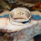 Sterling silver ring with turquoise set in the rectangular bezel and abstract stamped band.