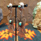 Sterling silver bird earrings with turquoise set in the notched bezel as the centerpiece.