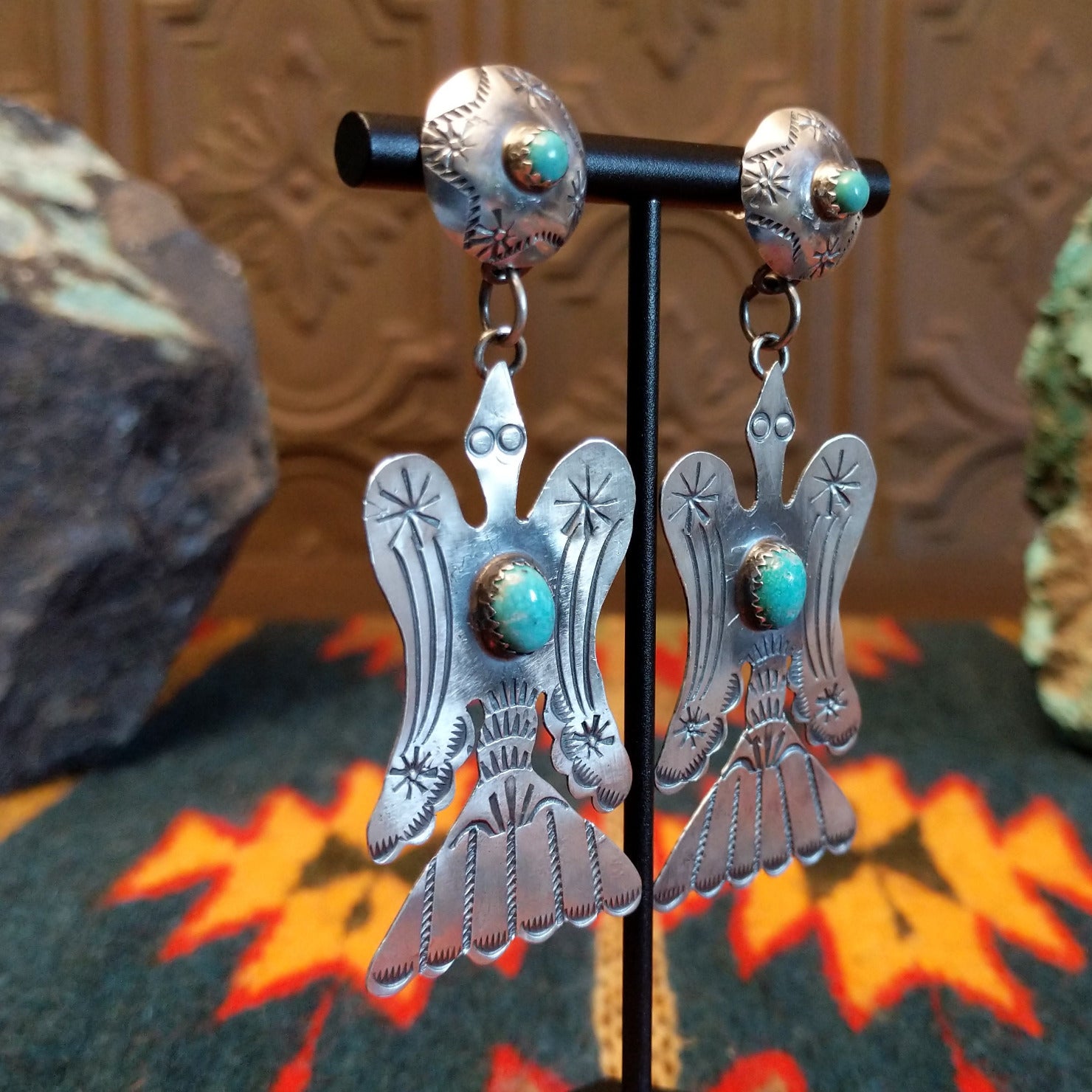 Sterling silver bird earrings with turquoise set in the notched bezel as the centerpiece.