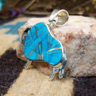 Sterling silver bison pendant with turquoise inlaid.