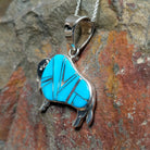 Handcrafted sterling silver turquoise buffalo inlay pendant by Evangie David, featuring a traditional buffalo design; side view.